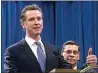  ?? RICH PEDRONCELL­I / AP FILE ?? In this 2019, file photo, Gov. Gavin Newsom, left, flanked by Attorney General Xavier Becerra, right, answers a question during a news conference in Sacramento.