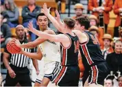  ?? Noah K. Murray/Associated Press ?? Yale forward EJ Jarvis, left, looks for help against Princeton guard Matt Allocco (14) and forward Zach Martini during the first half of the Ivy League championsh­ip on Sunday.