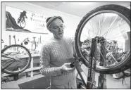  ??  ?? Steve Marquess, a volunteer from Bentonvill­e, trues a bicycle wheel Dec. 26 at Pedal it Forward NWA in Bentonvill­e.