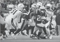  ?? Associated Press photo ?? New England Patriots running back Sony Michel (26) runs from Los Angeles Chargers outside linebacker Kyle Emanuel (51) during the second half of an NFL divisional playoff football game, Sunday in Foxborough, Mass.