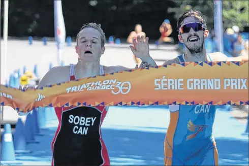  ?? SUBMITTED ?? Charlottet­own native Martin Sobey, left, crosses the finish line in the Grand Prix final A at the recent Gatineau triathlon last moNth in Gatineau, Que. Sobey won the elite division over Quebec’s Edouard Garneau, right, to take the gold medal by two-tenths of a second.