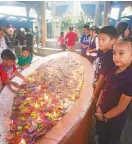  ??  ?? Thousands of candles lit up daily by Marian pilgrims in Manaoag Shrine.