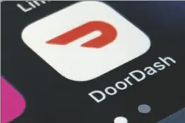  ??  ?? THE DOORDASH APP IS SHOWN ON A SMARTPHONE on Feb. 27,
2020, in New York. In 2020, many people took to working remotely in sweatpants, hopped onto an expensive high-tech exercise bike and had their favorite restaurant dish delivered, perhaps by a driver trying to earn an extra buck and hoping not to catch the coronaviru­s.