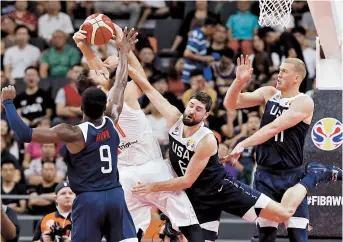  ??  ?? Serbia’s Nikola Milutinov in action with Jaylen Brown (left), Joe Harris and Mason Plumlee (right) of the United States during their FIBA Basketball World Cup 5th-8th classifica­tion match in Dongguan, Guangdong Province, yesterday. — Reuters