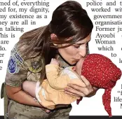  ??  ?? Turkish soldier takes care of a baby at airport