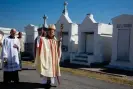  ?? Photograph: Jim West/Alamy ?? Archbishop Gregory Aymond leads the blessing of the graves at St Louis No 3 cemetery on All Saints Day.