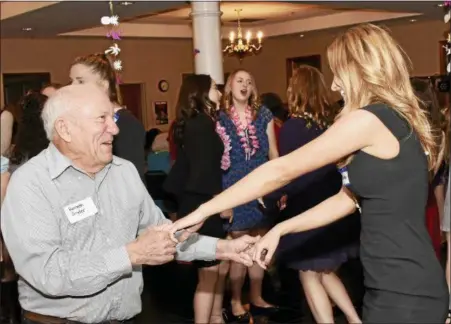  ?? JESI YOST — DIGITAL FIRST MEDIA ?? Kenneth Snyder shows Boyertown Area High School senior Charlotte Calautti a few dance moves at Senior-Senior Prom held at The Center at Spring Street March 9.