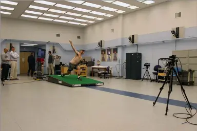  ?? PAT EATON-ROBB — THE ASSOCIATED PRESS ?? Central Connecticu­t pitcher Michael DeLease throws off a smart mound at the Center for Motion Analysis in Farmington, Conn. The technology allows scientists to better study pitching mechanics to enhance efficiency and prevent injuries.