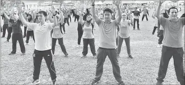  ??  ?? Hii (left, front row) takes part in an aerobic session with the participan­ts before the health walk.