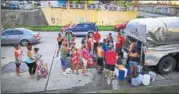  ?? REUTERS ?? Puerto Rico residents wait in line to collect water from a truck following damages caused by Hurricane Maria.