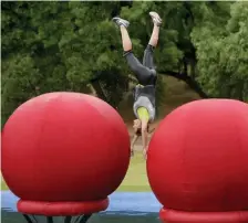  ??  ?? FLIPPING OUT: A contestant is upended in an obstacle course on ‘Wipeout.’