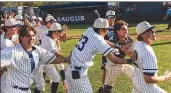  ?? Chris Torres/The Signal ?? The Saugus Centurions varsity baseball team celebrates on the field after defeating Castaic.