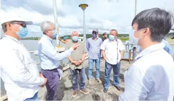  ??  ?? State Water Department director Edward Lingkapo (second from left) briefing Bung Moktar (third from left) and other officials during the visit to the water treatment plant.