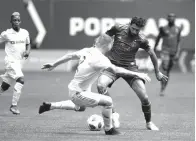  ?? Associated Press ?? ■ Portland Timbers' Diego Valeri (8) tries to dribble past LAFC's Jordan Harvey (2) during an MLS soccer game Saturday in Portland, Ore.