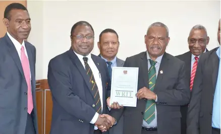  ??  ?? From left to right, Official Secretary to Governor General John Yamen, Electrol Commission­er Patilias Gamato, Ruben Kaiulo, and Governor General Sir Bob Dade with one of the 19 writs returned at Government House in Port Moresby on Monday.