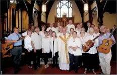  ?? Special to the Democrat-Gazette ?? The Retreat Singers today, in Trinity Episcopal Cathedral, surround the church’s dean and rector, the Rev. Christoph Keller (center).