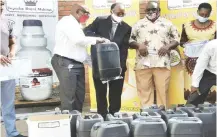  ??  ?? Ingwebu Breweries officials handover sanitisers and other Personal
Protective Equipment to John Tallach and Matopo High schools
last week