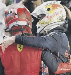  ?? ?? 0 Runner-up Charles Leclerc, left, greets Verstappen after the race