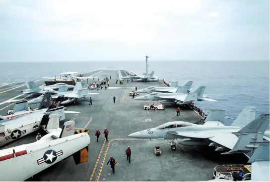  ??  ?? A US aircraft carrier prepares to take part in the Malabar military drills, off Japan’s southernmo­st island of Okinawa in this file photo. (Reuters)