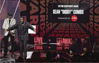  ?? CHRIS PIZZELLO | AP ?? Sean “Diddy” Combs accepts the lifetime achievemen­t award at the BET Awards on Sunday at the Microsoft Theater in Los Angeles.