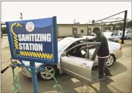  ?? Hearst Connecticu­t Media file photo ?? Manager Anthony Buchanan santizes a car at Hearst Top Workplace Splash Carwash in Fairfield on Sept. 15.