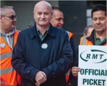  ?? ?? Picket line: RMT boss Mick Lynch joins workers