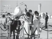  ?? SEBASTIAN SCHEINER/AP ?? Ethiopian immigrants wave Israeli flags as they arrive last year at Ben Gurion Airport near Tel Aviv.