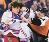  ?? DERIK HAMILTON/AP ?? Nicolas Deslaurier­s, right, and Matt Rempe fight during the first period of Saturday’s game in Philadelph­ia.