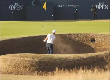  ?? The Associated Press ?? Paul Casey of England plays out of a bunker on the 18th hole during the second round of the British Open in Carnoustie, Scotland, on Friday. The tournament continues today and is scheduled to conclude on Sunday.