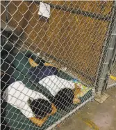  ?? Ross D. Franklin / Associated Press 2014 ?? Two detainees sleep in a holding cell at the border in Arizona in 2014.