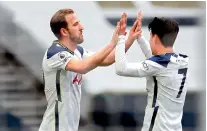  ??  ?? Harry Kane (L) celebrates with Son Heung-min after scoring the opening goal