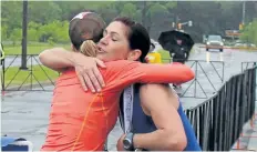  ?? ALISON LANGLEY/POSTMEDIA NEWS ?? Michelle Spencer, right, the winner of the Niagara Falls Women's Half Marathon, congratula­tes another runner Sunday.