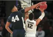  ?? JULIE JACOBSON — THE ASSOCIATED PRESS ?? Penn State forward Julian Moore (44) blocks a shot attempt by Purdue forward Vincent Edwards (12) during the first half of an NCAA Big Ten Conference tournament semifinal college basketball game, Saturday.