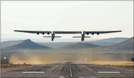  ??  ?? PHOTOS BY STRATOLAUN­CH SYSTEMS CORP VIA AFP/GETTY IMAGES The Stratolaun­ch plane flies above the California desert Saturday. It was the first test flight of the aircraft, whose wingspan is almost double that of an Airbus A380.