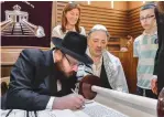  ?? (David Osipov) ?? RABBI YEHUDA TEICHTAL and the donors of the new Torah scroll attend this week’s event at the Münstersch­e Street Synagogue in Berlin.