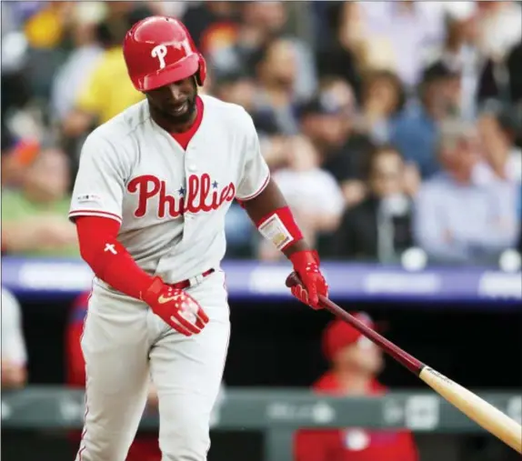  ?? DAVID ZALUBOWSKI — THE ASSOCIATED PRESS ?? Phillies’ Andrew McCutchen reacts as he flies out with two runners on base against Colorado Rockies starting pitcher Jon Gray in the fifth inning.