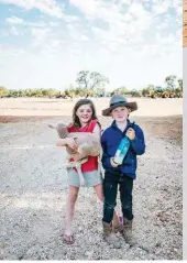  ??  ?? CLOCKWISE, FROM ABOVE Zane bought the property, which includes the shearing shed, from his family about seven years ago; Louise and Zane say their lives represent far more than just farming and they are grateful to be able to teach that to their two children, daughter Keeley and son Clancy; inside the shearing shed; Keeley and Clancy with a lamb. FACING PAGE Seven-year-old Clancy is a great help caring for their Dohne merino sheep and helping his Dad distribute hay for feed.