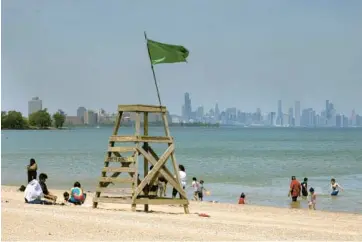  ?? ERIN HOOLEY/CHICAGO TRIBUNE ?? People gather at Rainbow Beach on Memorial Day in the South Shore neighborho­od of Chicago.