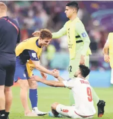  ?? — AFP photo ?? USA’s Josh Sargent (left) consoles Iran’s Mehdi Taremi at the end of the match.