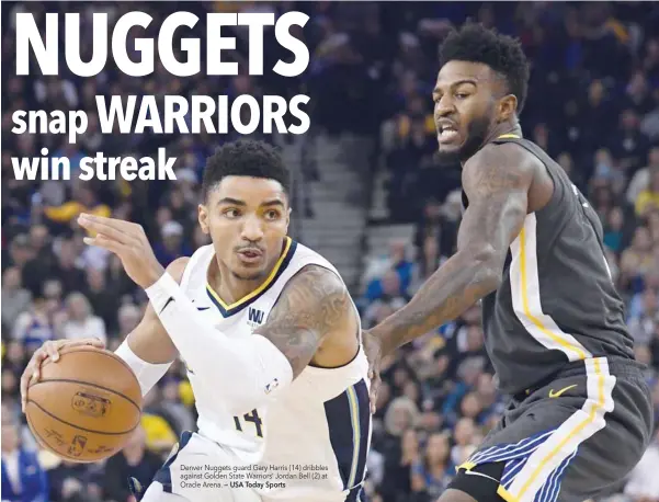  ?? — USA Today Sports ?? Denver Nuggets guard Gary Harris (14) dribbles against Golden State Warriors’ Jordan Bell (2) at Oracle Arena.