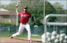  ?? LYNNE SLADKY — THE ASSOCIATED PRESS ?? Philadelph­ia Phillies starting pitcher Aaron Nola throws during batting practice at baseball spring training camp.