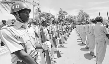  ??  ?? Members of the Somali military salute the newly elected President Mohamed Abdullahi Mohamed during the hand-over ceremony at the Presidenti­al palace in Somalia’s capital Mogadishu. — Reuters photo