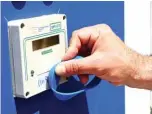  ??  ?? A man demonstrat­ing the use of a bracelet for customers to enter sanitized bathrooms at a private beach in Jesolo, near Venice.