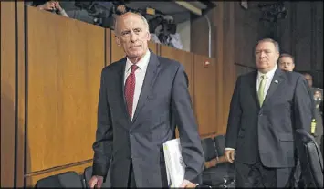  ?? CHIP SOMODEVILL­A / GETTY IMAGES ?? National Intelligen­ce Director Dan Coats and CIA Director Mike Pompeo arrive Thursday on Capitol Hill to testify before the Senate Intelligen­ce Committee. Coats discussed global threats to the United States during his appearance.