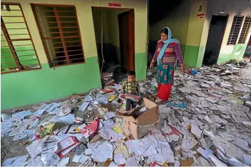  ?? AP ?? Books and papers lie scattered after a Hindu mob vandalised a school in Shiv Vihar, New Delhi. Nearly 30 people have been killed in the city’s worst rioting in decades, and authoritie­s expect the toll to rise, with hospitals overflowin­g with dozens of injured people.