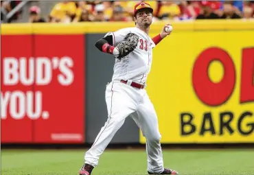  ?? DAVID JABLONSKI / STAFF ?? Reds right fielder Jesse Winker throws the ball back to the infield after yet another hit by the Nationals on Sunday, when the Reds gave up 14 runs in a 14-4 drubbing at Great American Ball Park in Cincinnati.