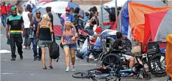  ?? HerALD FILe ?? TENT FIRE: Atkinson Street is packed with people and a number of tents where known drug use and dealing takes place. One tent caught fire around 4 a.m. Saturday morning.