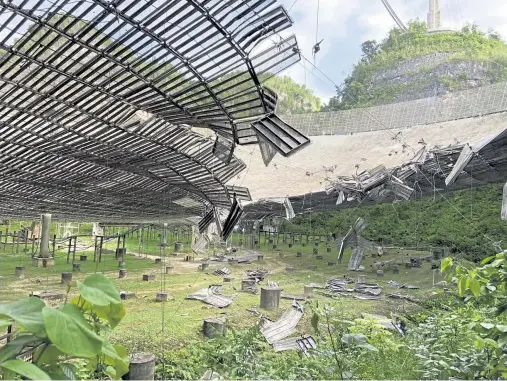  ?? Provided by Arecibo Observator­y via © The New York Times Co. ?? A 100- foot- long gash created by a falling cable is seen from below the Arecibo Observator­y in Arecibo, Puerto Rico, on Aug. 11.