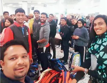  ??  ?? Members of the Indian contingent are all smiles as they strike a pose after landing at the Birmingham airport for the All England Open badminton championsh­ips starting on Tuesday.