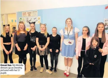  ??  ?? Great fun Ms Melville dresses up as Dorothy, pictured with her S1 pupils